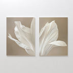 The Ivory Petals Set of 2 features canvas panels with soft-focus close-ups of white flower petals against a beige background, creating minimalist and elegant wall art ideal for sophisticated living room decor.