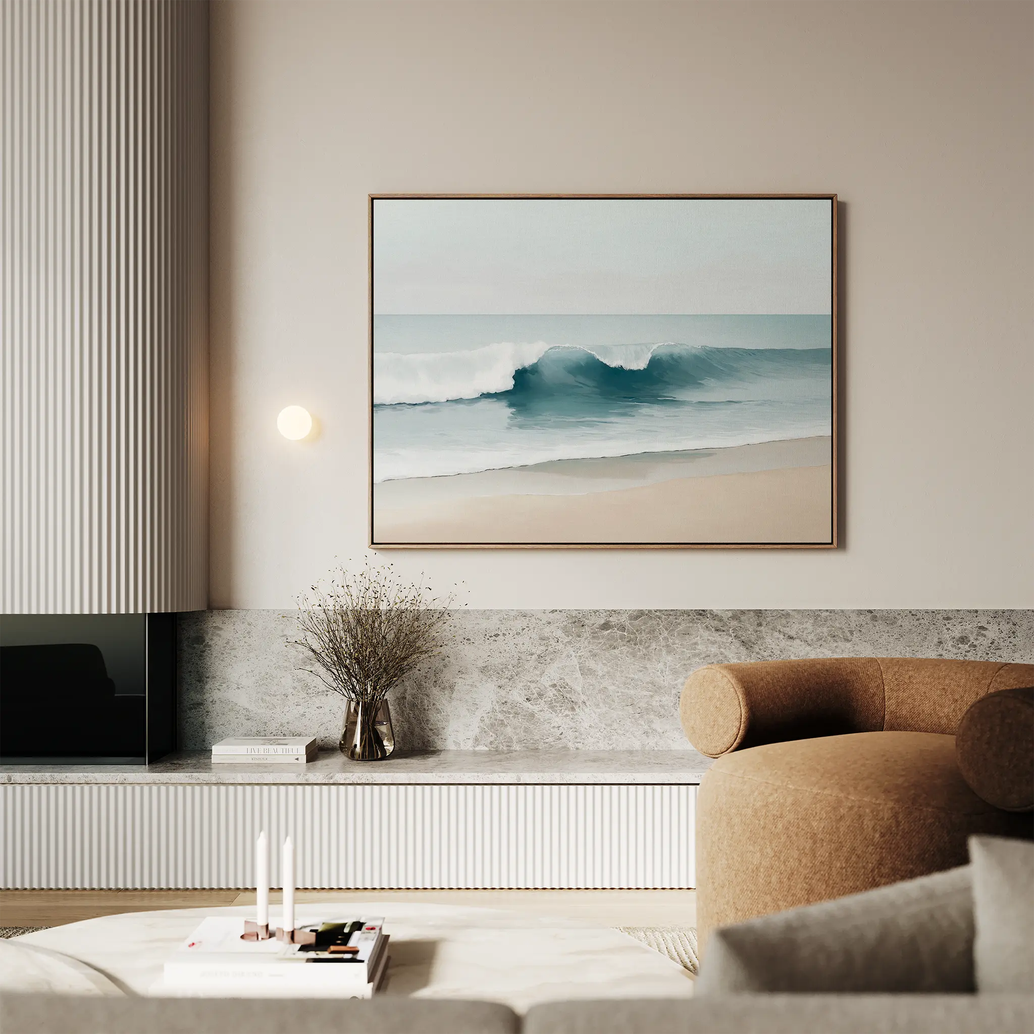 A modern living room with a beige armchair, marble surfaces, and the Lapping Tide Canvas Art depicting waves displayed above a minimalist shelf adorned with a vase and decor items.