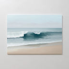 Lapping Tide Canvas Art captures gentle waves on a sandy shore beneath a soft blue sky, bringing modern coastal tranquility to your space.