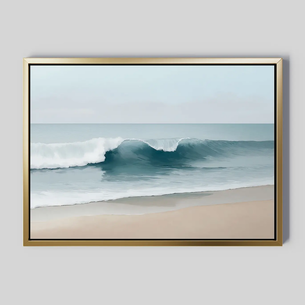 The Lapping Tide Canvas Art showcases a tranquil seascape with gentle waves on a sandy shore beneath a cloudy sky, highlighted by soft blue and tan tones and set in a gold-colored frame for modern coastal style.