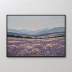 The Lavender Terrain Canvas Art features a serene field of purple wildflowers and white blooms with rolling hills and distant blue mountains under a cloudy sky, bringing minimalist elegance to any plain white wall.