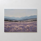 Lavender Terrain Canvas Art features a calming print of a blooming lavender field with distant hills and mountains under a soft, cloudy sky in purple, blue, and muted earth tones—ideal as large wall art for serene spaces.