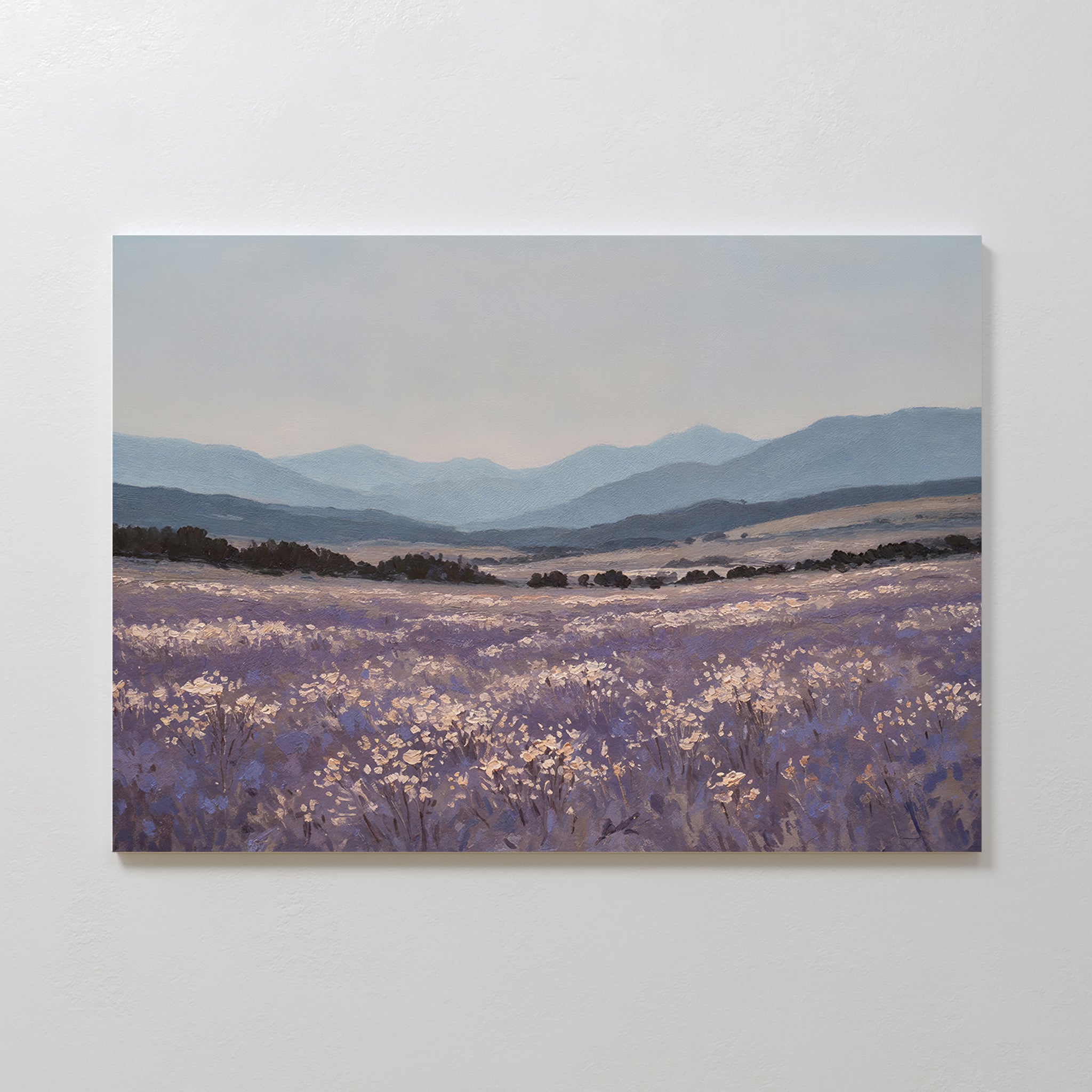 Lavender Terrain Canvas Art features a calming print of a blooming lavender field with distant hills and mountains under a soft, cloudy sky in purple, blue, and muted earth tones—ideal as large wall art for serene spaces.