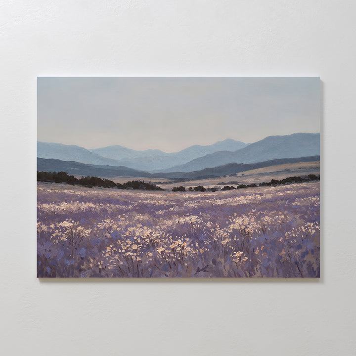 Lavender Terrain Canvas Art features a calming print of a blooming lavender field with distant hills and mountains under a soft, cloudy sky in purple, blue, and muted earth tones—ideal as large wall art for serene spaces.