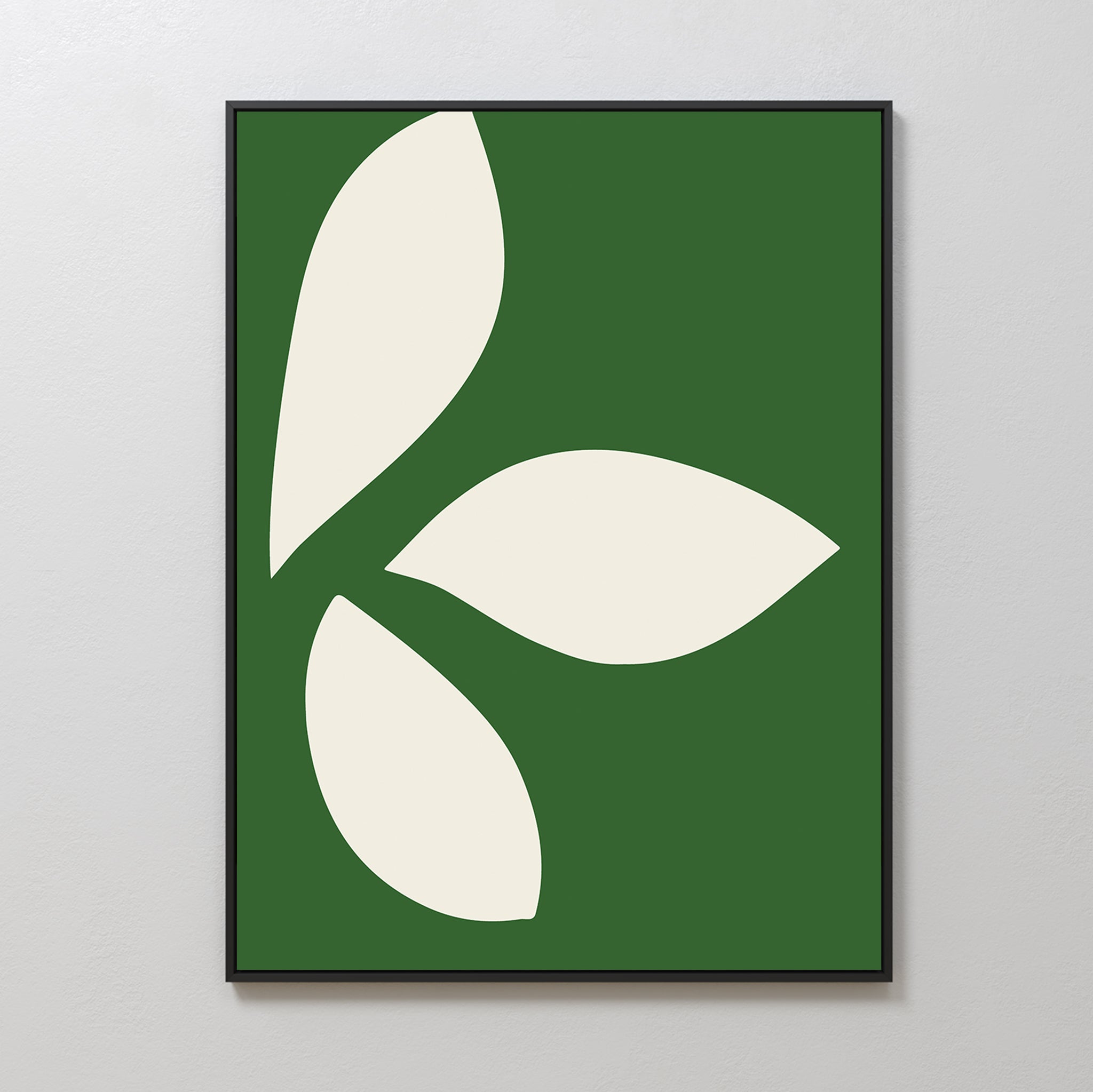 Leaf Silhouette Abstract Canvas Art showcases three large cream leaf shapes on a green background in a radial pattern. With smooth, curved edges and balanced spacing, it adds modern elegance to any living room decor.