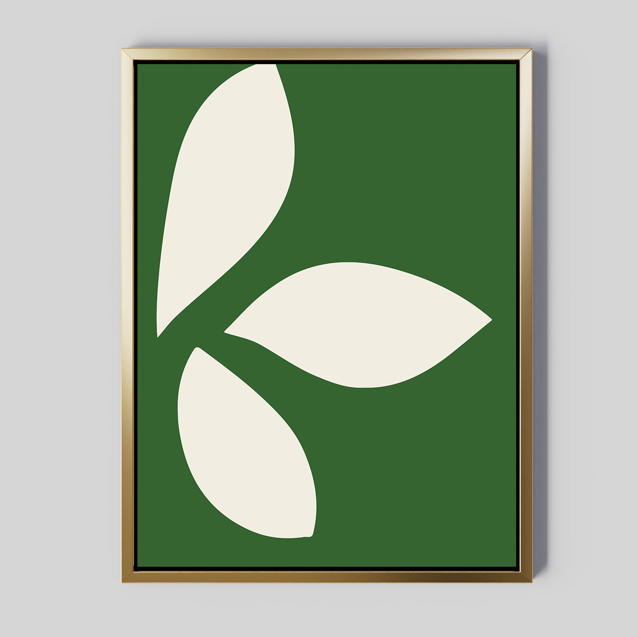 The Leaf Silhouette Abstract Canvas Art features three bold white leaves in a circular design on a dark green background, set in a metallic gold frame—ideal minimalist wall art to add modern elegance to any living room decor.