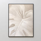 Leaf Whisper Abstract Canvas Art features a close-up of a stylized white monstera leaf with flowing lines on a light beige background, ideal minimalist wall art for enhancing any light-colored room.