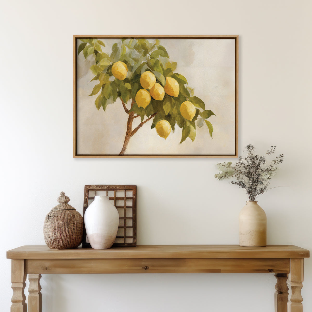 A wooden table with vases and dried flowers sits by a white wall, above which hangs the Lemon Essence Canvas Art featuring ripe yellow lemons—perfect Mediterranean-inspired decor for your kitchen.