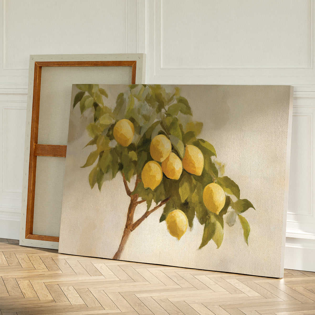 The Lemon Essence Canvas Art, featuring a lemon tree branch with green leaves and yellow lemons, leans against a wall beside a blank canvas on a wooden floor—perfect rustic decor for Mediterranean kitchens.