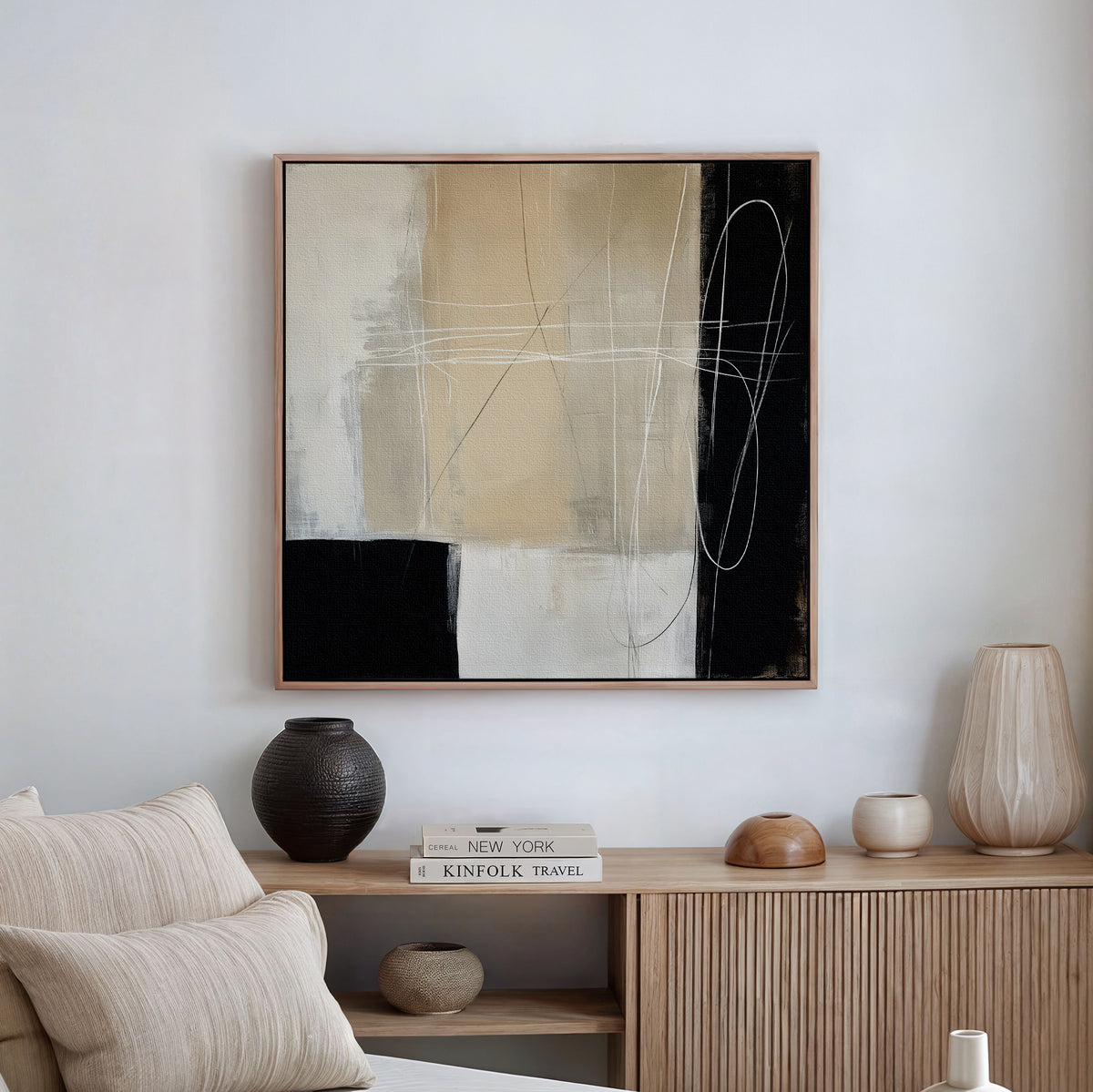 A modern living room features the Light and Shadow Abstract Canvas Art above a wooden console with ceramic vases, a candle, and books. A beige sofa with cushions sits in the foreground, creating elegant decor.