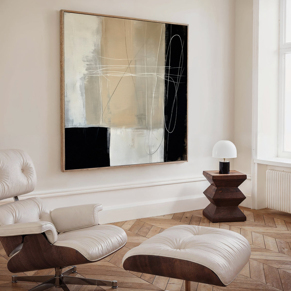 A modern living room with a cream Eames lounge chair and ottoman, Light and Shadow Abstract Canvas Art in neutral tones, a geometric wooden side table, and a small white lamp by a large window with natural light.