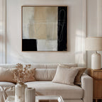 A modern living room features a beige sofa, neutral cushions, a wooden side table with a ceramic lamp, dried flowers on the coffee table, and Light and Shadow Abstract Canvas Art as the striking focal point of the decor.