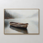 Lonely Boat Canvas Art features a framed painting of a wooden rowboat on calm, misty water with a foggy forest and distant shoreline—a serene wall art piece perfect for bringing peaceful decor to any space.