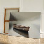 Lonely Boat Canvas Art features a wooden rowboat on calm water with misty trees, leaning against a wall beside an empty canvas—ideal lakeside decor to bring peaceful vibes to rooms with light walls and parquet flooring.