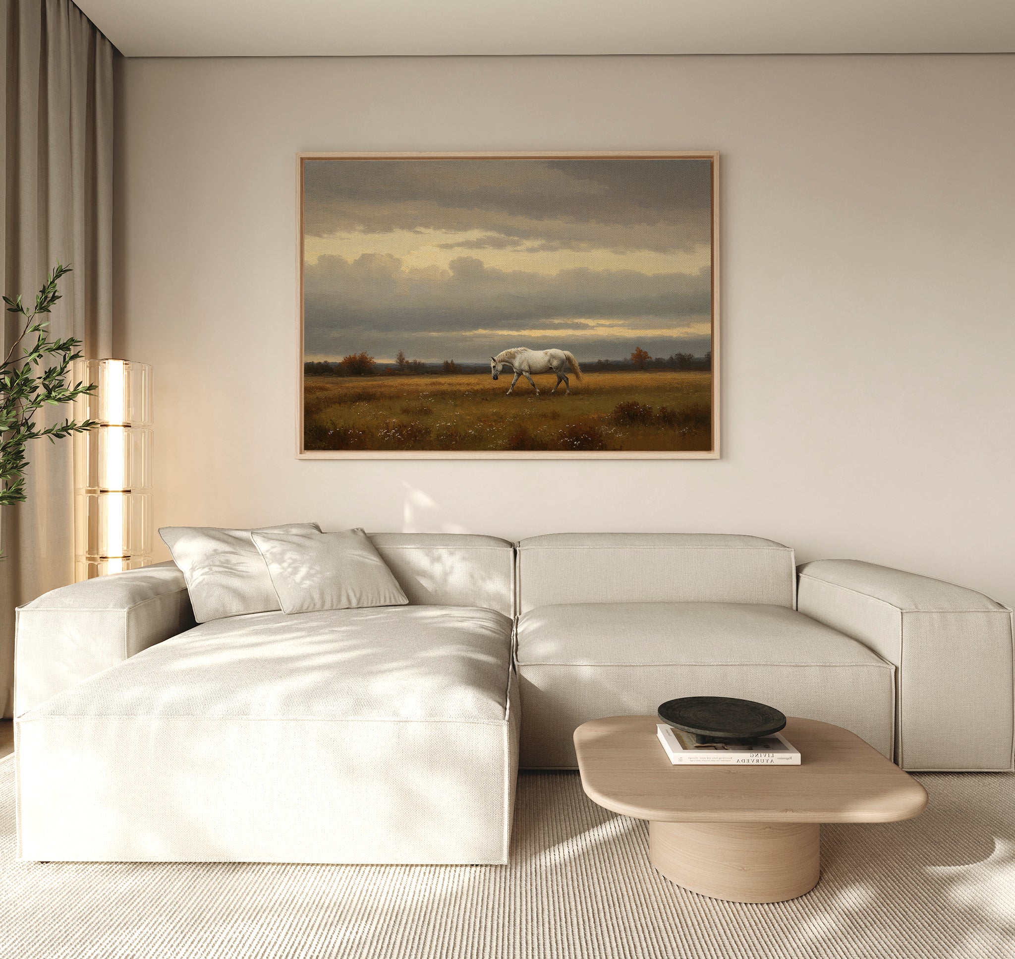 A modern living room with a light beige sectional sofa, wooden coffee table, and the Low Light Walk Canvas Art featuring a white horse in a grassy field above the sofa, all bathed in natural light.