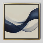 The Tidal Flow Canvas Art showcases abstract navy and gray waves on a light beige background, framed in sleek gold. This minimalist wall decor brings movement and elegance—ideal for any modern space.