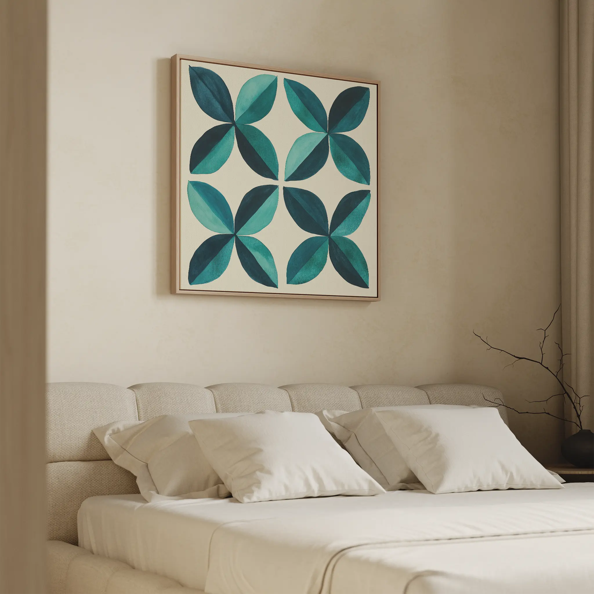 A modern bedroom features a cream upholstered bed with white bedding and four pillows. Above the bed hangs the Marine Mosaic Canvas Art, showcasing overlapping blue and teal petal designs. A bare decorative branch sits on a side table.