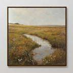 The Marshland Stream Canvas Art showcases a peaceful meadow with wildflowers, tall grass, and a reflective stream—an ideal addition to serene living room decor.