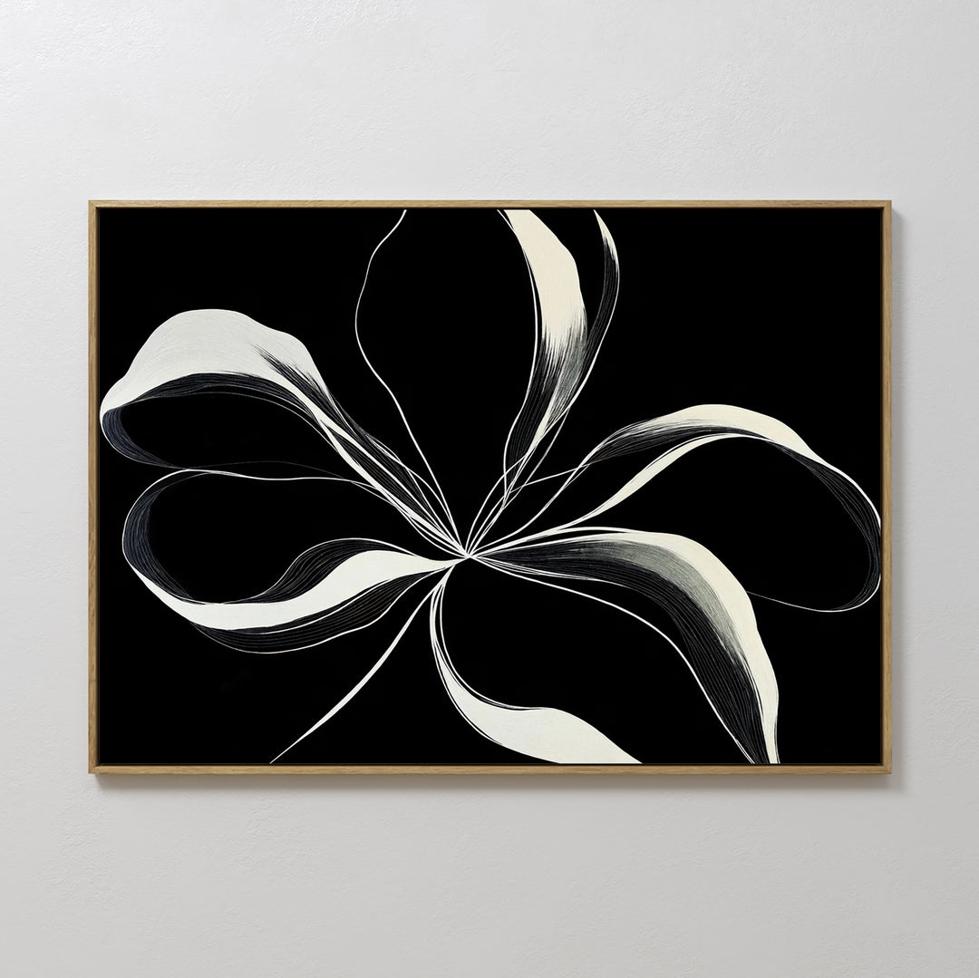 Midline Motion Canvas Art showcases abstract black and white ribbon-like lines forming a floral shape on a black background, framed in light wood. Perfect minimalist wall decor for a modern living room.