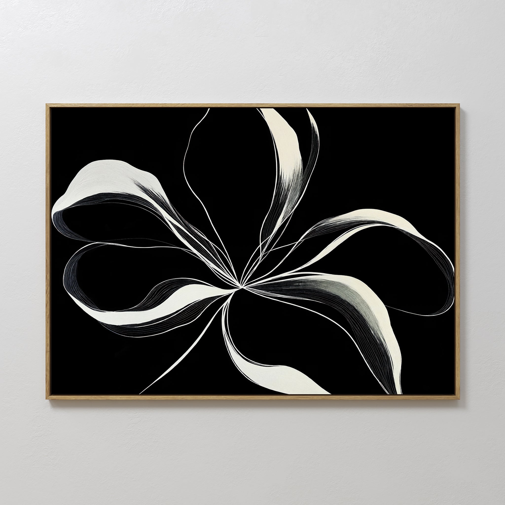 Midline Motion Canvas Art showcases abstract black and white ribbon-like lines forming a floral shape on a black background, framed in light wood. Perfect minimalist wall decor for a modern living room.