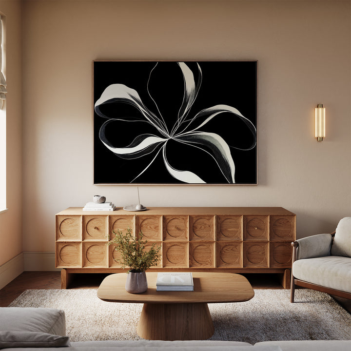 A modern living room features a light beige sofa, wooden coffee table, and sideboard. Above the sideboard hangs the Midline Motion Canvas Art. Soft lighting and minimal décor create a calm, cozy atmosphere.