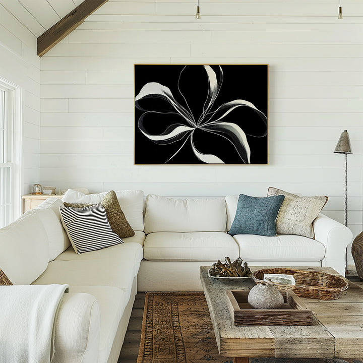 A bright living room with a white sectional, neutral and blue pillows, rustic wood coffee table, and the striking Midline Motion Canvas Art brings modern style to the shiplap wall.