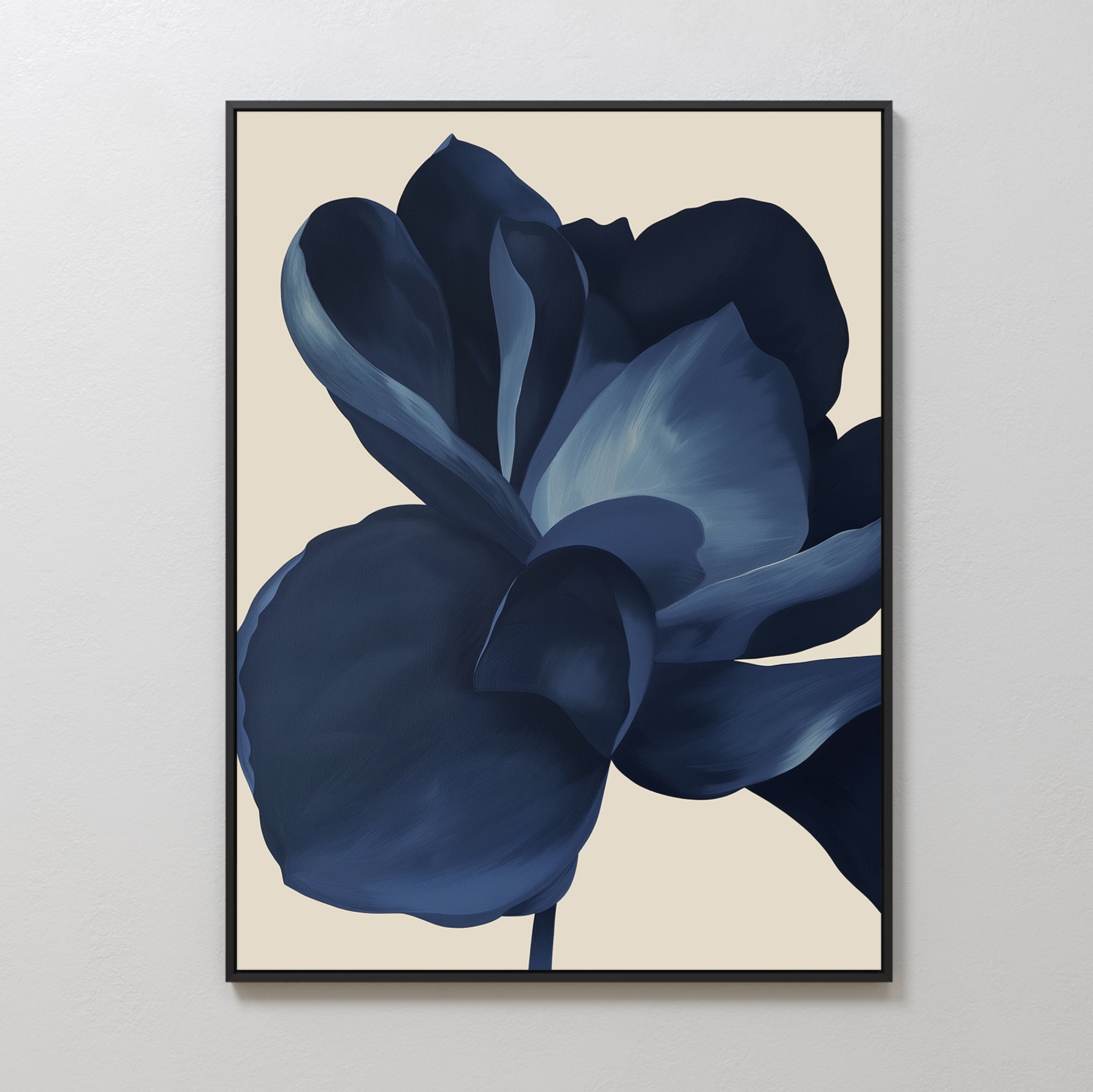 The Midnight Bloom Abstract Canvas Art features a minimalist design with a bold, stylized blue flower and layered petals on a light beige background, displayed in a frame against a white wall.