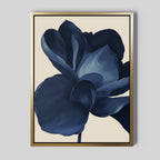Midnight Bloom Abstract Canvas Art features a large, abstract dark blue flower with soft, layered petals on a light beige background in a sleek gold frame—perfect minimalist wall decor for modern spaces.