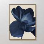 The Midnight Bloom Abstract Canvas Art is a framed minimalist wall decor featuring a large dark blue flower with layered petals on a light beige background, perfect for modern spaces.