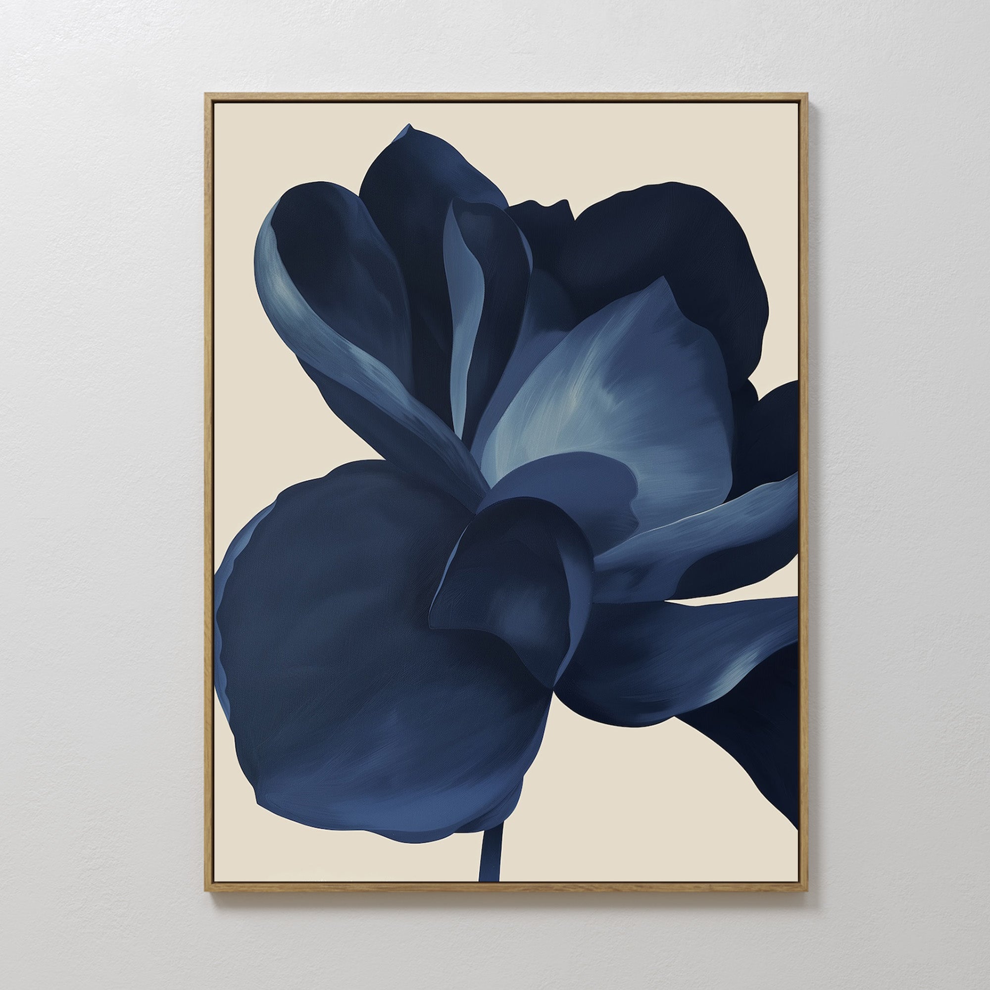 The Midnight Bloom Abstract Canvas Art is a framed minimalist wall decor featuring a large dark blue flower with layered petals on a light beige background, perfect for modern spaces.
