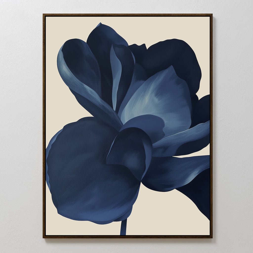 Minimalist wall art featuring a large dark blue flower with stylized petals on a light beige background, framed in black. The Midnight Bloom Abstract Canvas Art adds modern decor and abstract elegance to any space.