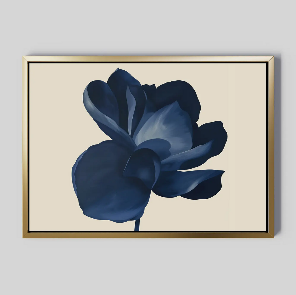 Midnight Bloom Canvas Art – Horizontal: A framed wall art print showcasing a single dark blue flower with layered petals on a light beige background in a gold frame, ideal for adding minimalist elegance and modern style to any space.