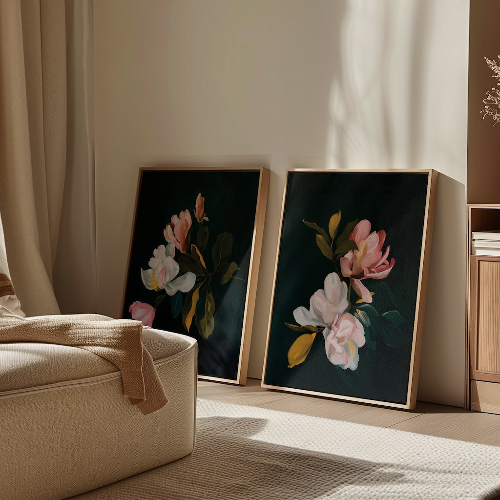 The Midnight Blossoms Set of 2 framed floral paintings leans against a light wall in a cozy room, with sunlight casting shadows across the art, beige sofa, and wooden furniture for an inviting home decor vibe.