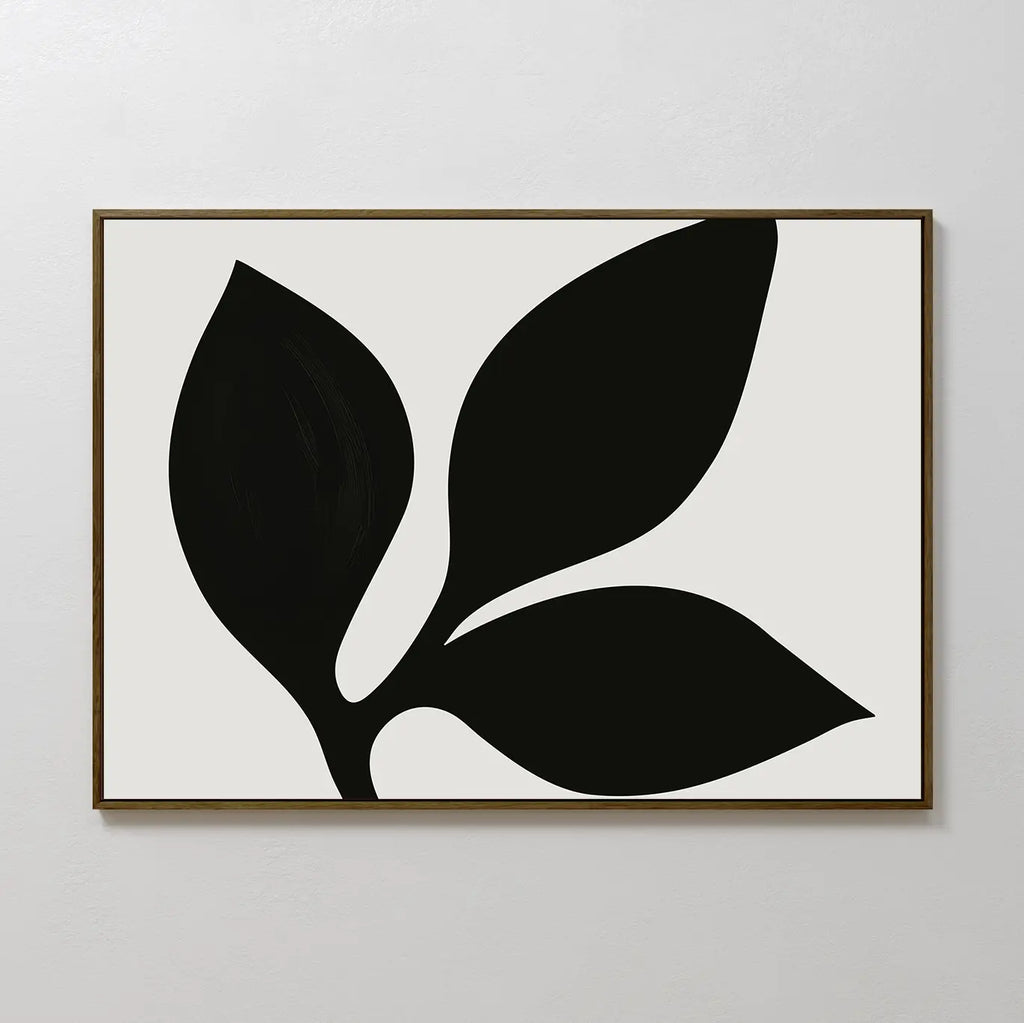 The Midnight Botanist Canvas Art showcases a bold black plant silhouette with three leaves on a white backdrop, framed in thin brown wood—an ideal choice for modern living room decor.