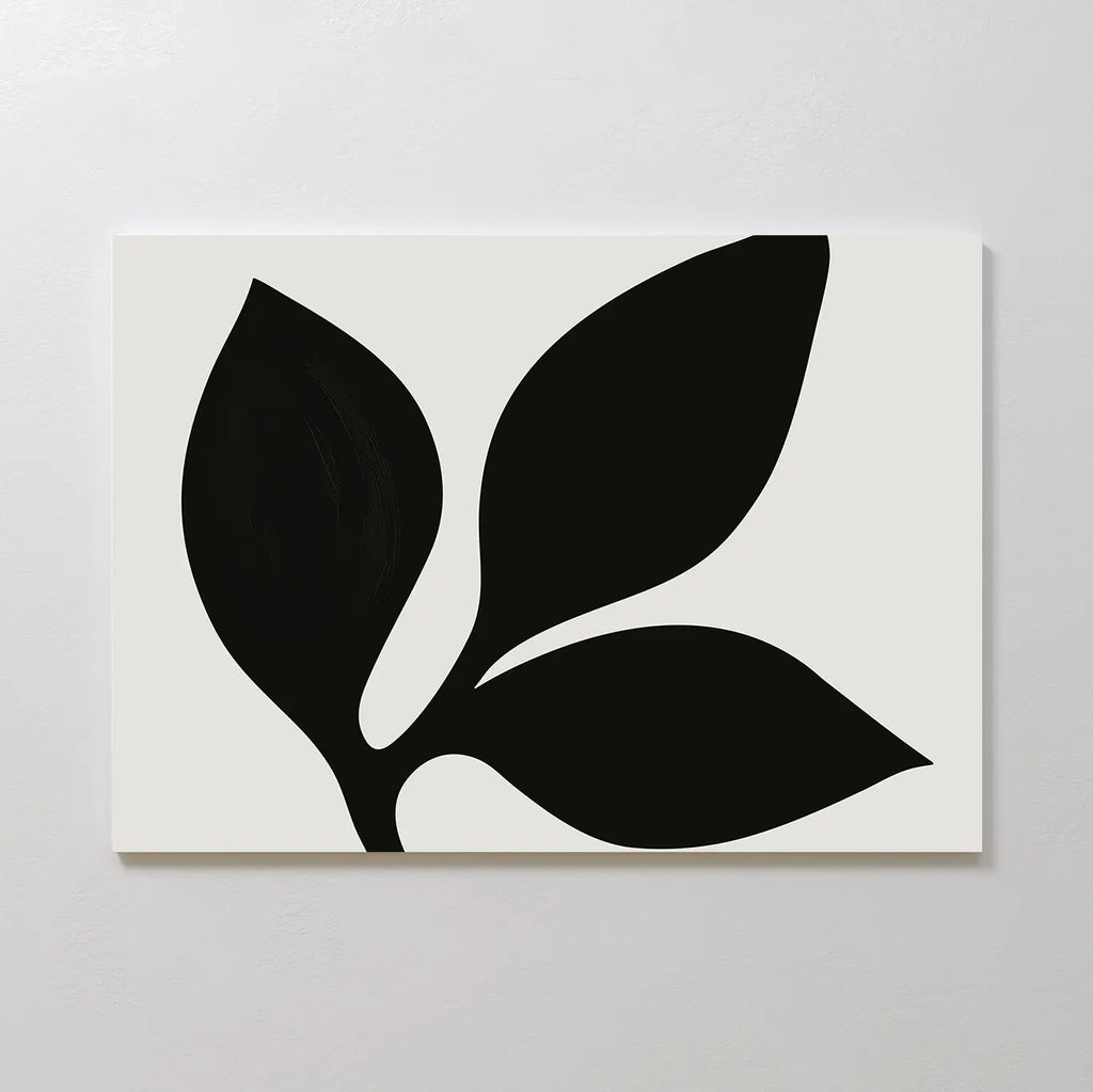 The Midnight Botanist Canvas Art showcases a minimalist white canvas with a striking black plant silhouette of three bold leaves, ideal as botanical wall art or stylish living room decor on light-colored walls.