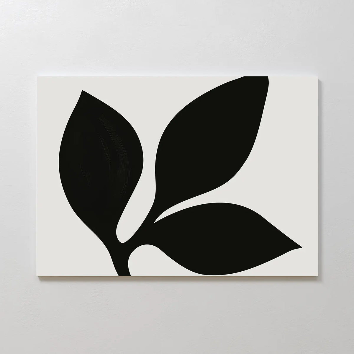 The Midnight Botanist Canvas Art showcases a minimalist white canvas with a striking black plant silhouette of three bold leaves, ideal as botanical wall art or stylish living room decor on light-colored walls.