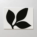 The Midnight Botanist Canvas Art showcases a minimalist white canvas with a striking black plant silhouette of three bold leaves, ideal as botanical wall art or stylish living room decor on light-colored walls.