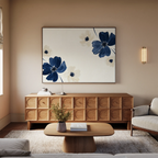 A modern living room with light walls features the Midnight Garden Canvas Art, showcasing blue and white flowers above a wooden sideboard, complemented by a round coffee table with a vase, a light sofa, and a light-colored rug.