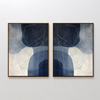 The Midnight Lines Set of 2 features abstract wall art with curved white and blue shapes and swirling lines on dark blue and light gray backgrounds, framed in dark wood—an elegant minimalist addition to any space.