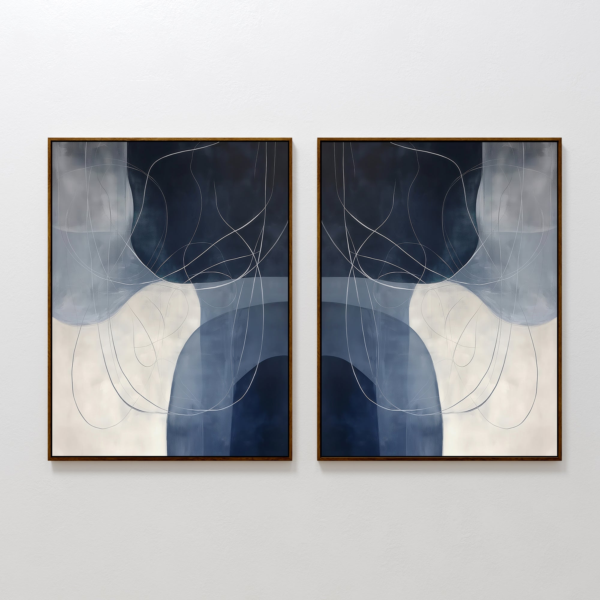 The Midnight Lines Set of 2 features abstract wall art with curved white and blue shapes and swirling lines on dark blue and light gray backgrounds, framed in dark wood—an elegant minimalist addition to any space.
