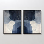 The Midnight Lines Set of 2 features abstract paintings in black frames with overlapping dark blue, gray, and white shapes accented by thin, curved lines, creating a modern, elegant look on any wall.