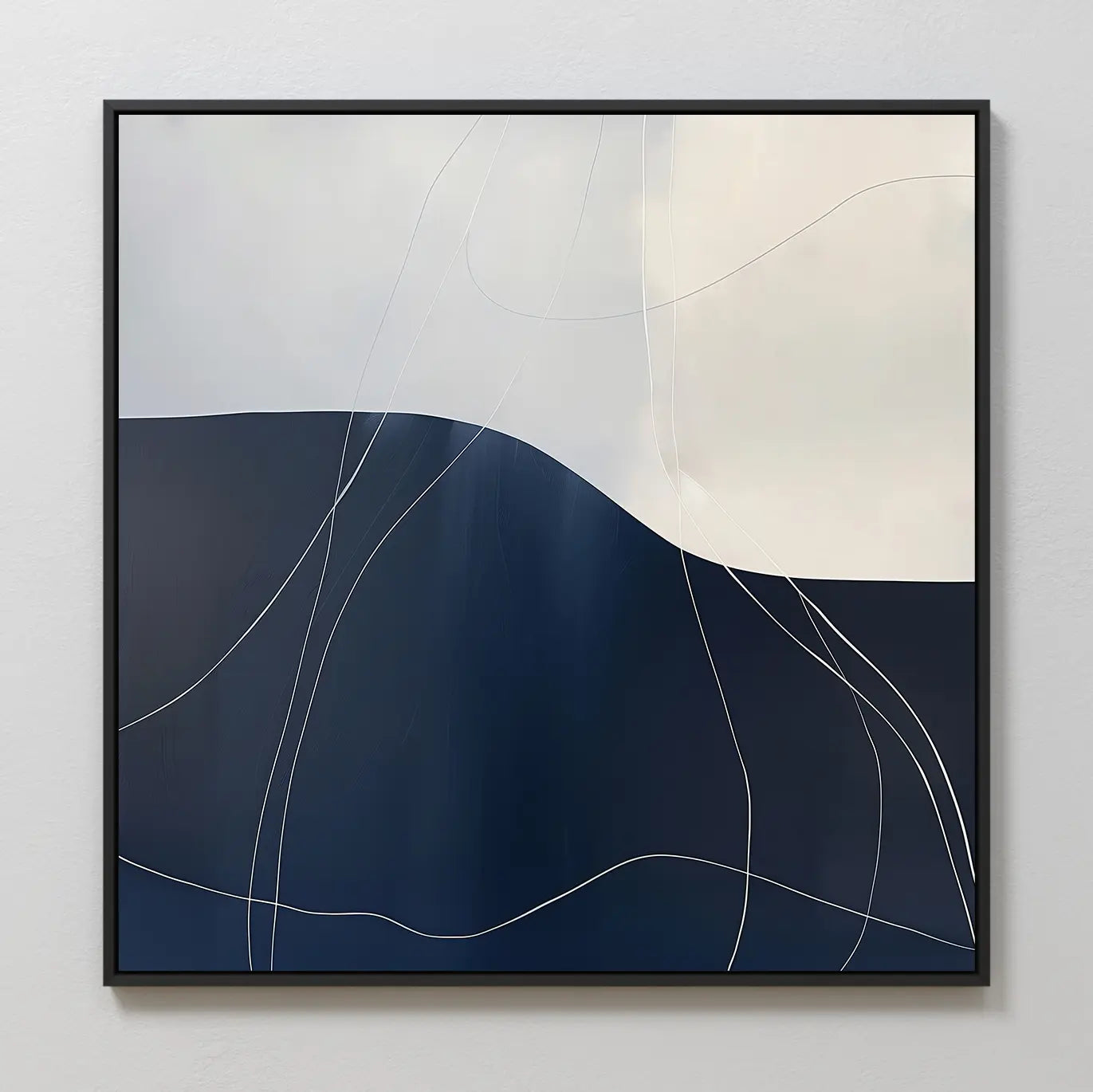 The Midnight Terrain Canvas Art features abstract dark blue and white tones intersected by thin white lines, with soft curves in a minimalist design. Framed in black, it’s perfect bedroom decor for a light gray wall.