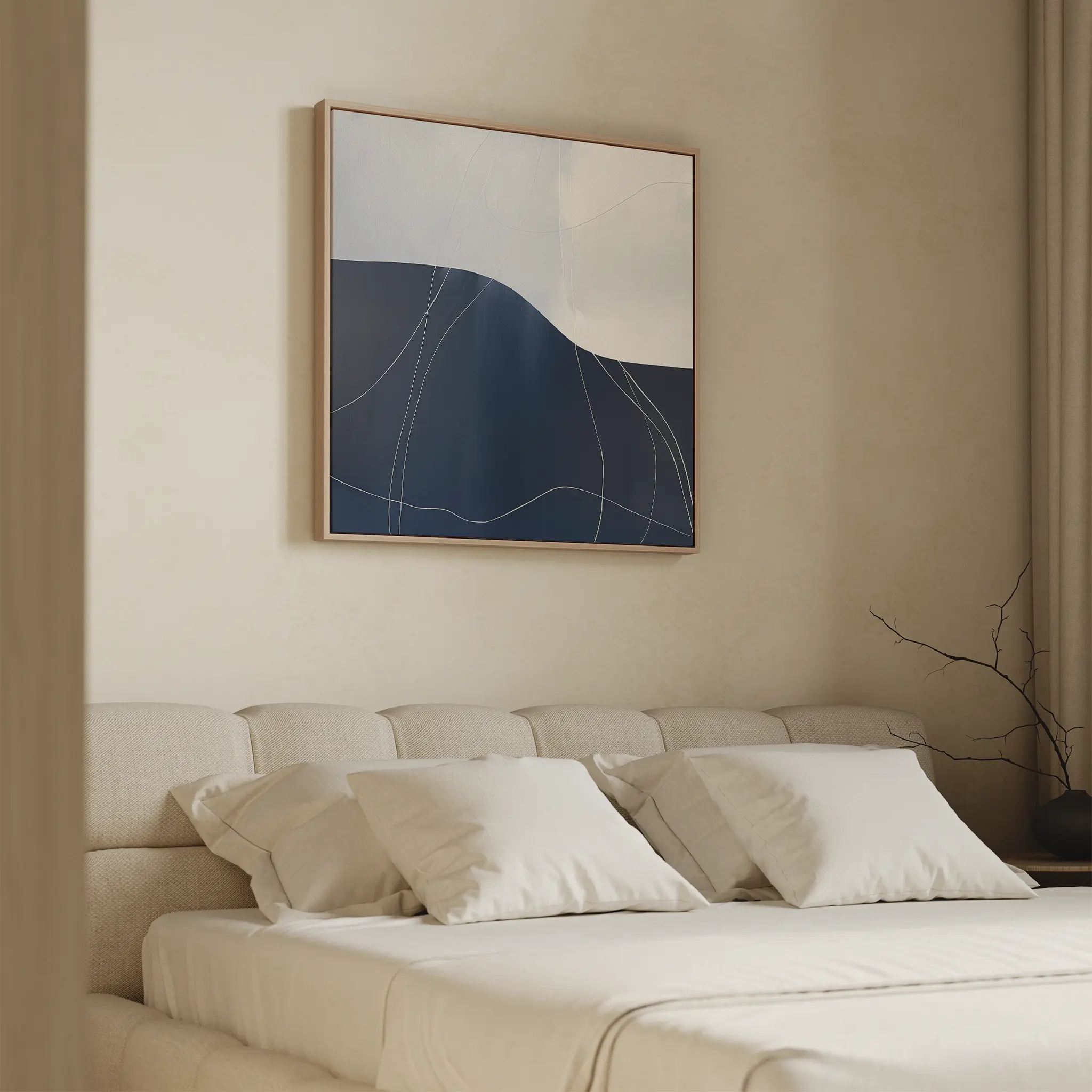 Minimalist bedroom with a beige upholstered bed, white bedding, and neutral walls. Above the bed hangs the Midnight Terrain Canvas Art in blue and white. A bare branch accent adds a subtle touch to the calming decor.