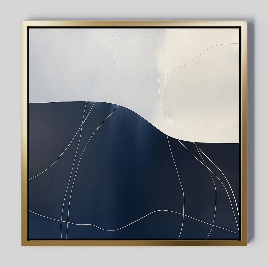 The Midnight Terrain Canvas Art features dark blue and light beige shapes, accented by thin, white curved lines and a gold frame—creating a striking minimalist abstract wall art piece ideal for modern bedroom decor.