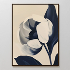 The Midnight Tulip Canvas Art showcases a large stylized flower in navy blue and cream on a light beige background, framed simply. This minimalist botanical piece features bold shapes—perfect for modern living room decor.