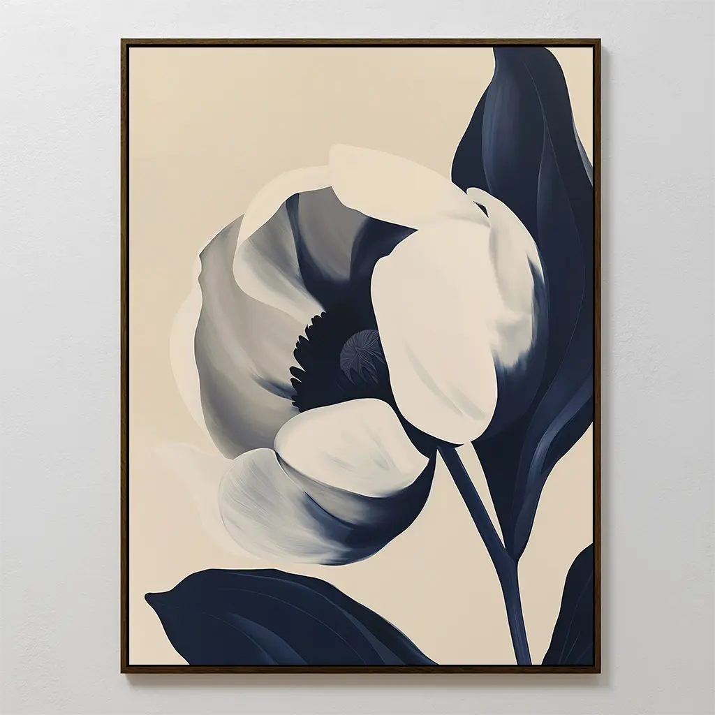 The Midnight Tulip Canvas Art showcases a large stylized flower in navy blue and cream on a light beige background, framed simply. This minimalist botanical piece features bold shapes—perfect for modern living room decor.