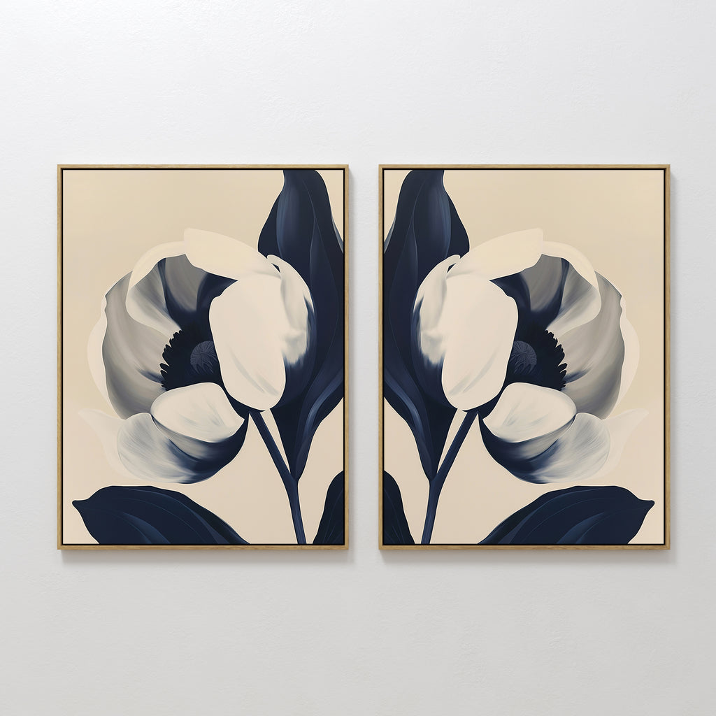 The Midnight Tulip Set of 2 features framed minimalist floral canvas paintings with dark blue and white tulip petals on beige backgrounds, ideal for modern botanical wall art or elegant living room decor.