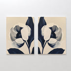 The Midnight Tulip Set of 2 features minimalist canvas prints with abstract large flowers—white petals and dark blue leaves—creating stylish botanical wall art, ideal for modern living room decor.