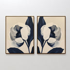 The Midnight Tulip Set of 2 features abstract floral prints in cream, white, and deep blue, adding a modern, minimalist touch to your living room with elegant, stylized botanical artwork.