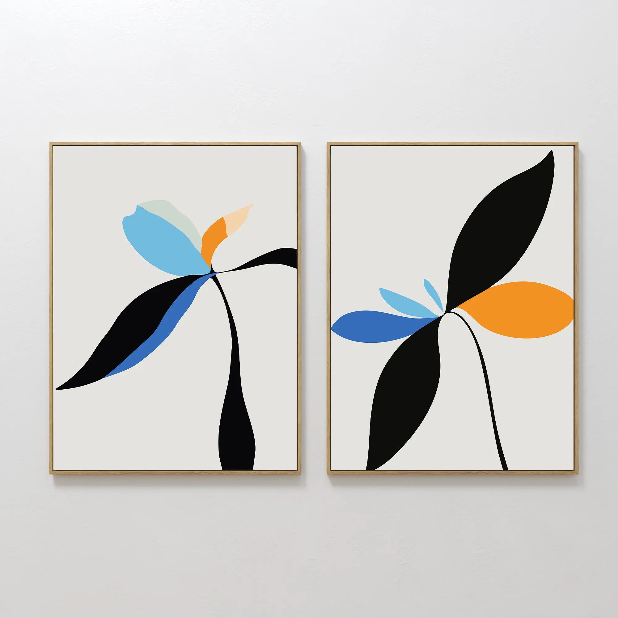 The Minimal Flora Set of 2 features framed abstract floral prints with bold, curved leaves in black, blue, orange, and pastel on white—ideal modern wall decor for any space.